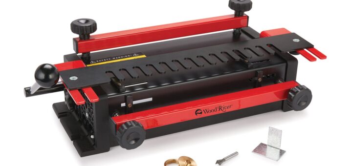 Red and black dovetail jig with slotted router template and two clamping bars