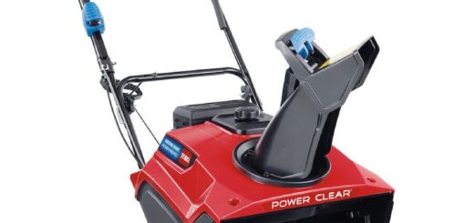 Red Toro Power Clear walk-behind single-stage snow blower with rubber auger, discharge chute and handle.